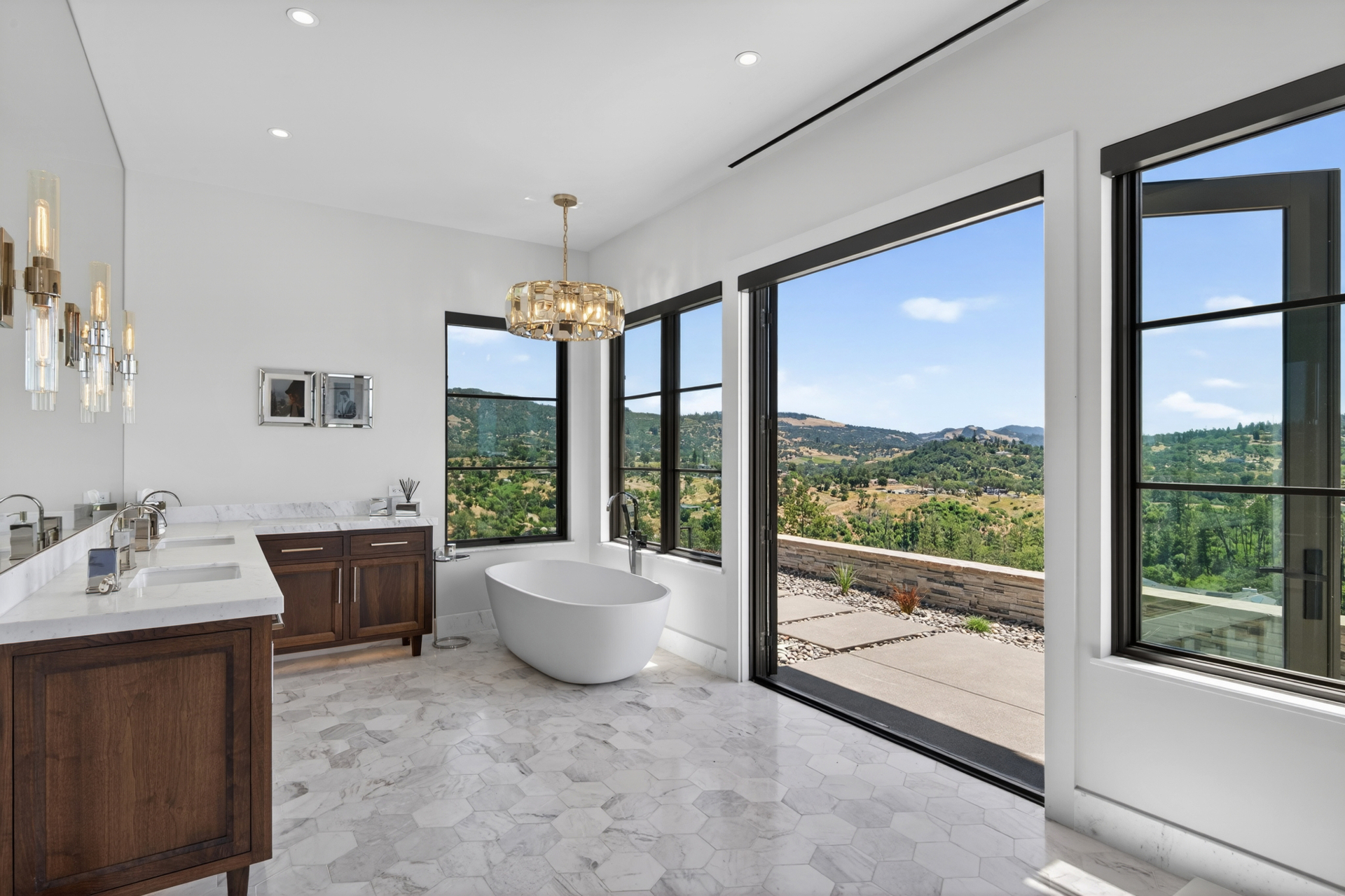 Luxury bathroom with hillside views and custom millwork vanities